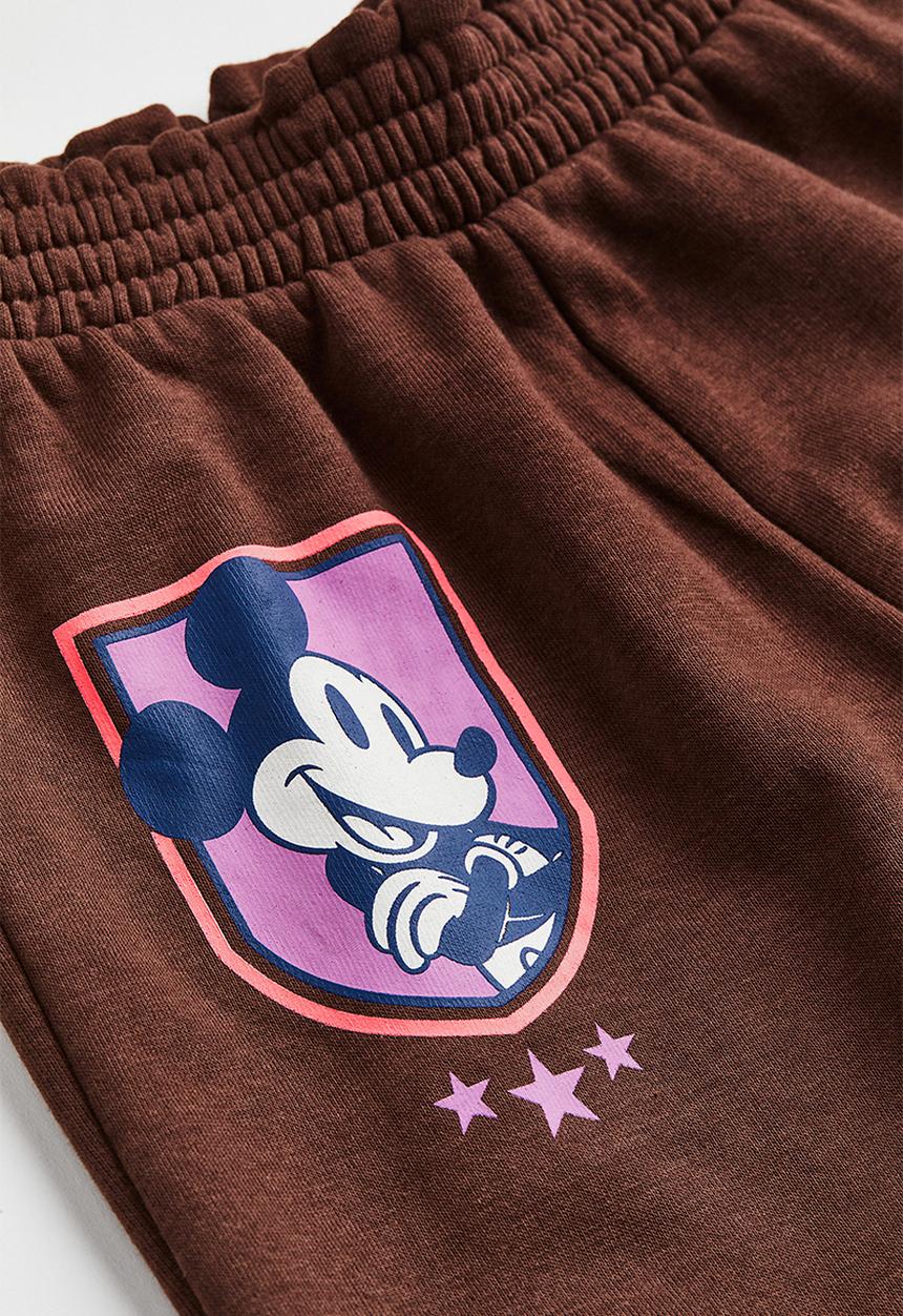 H&M - Printed joggers - dark brown/mickey mouse