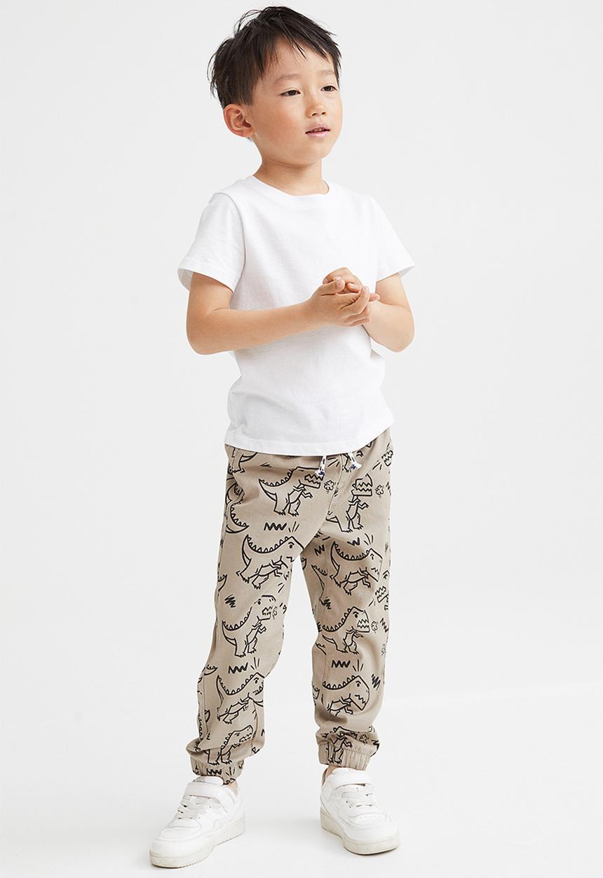 H&M - Relaxed fit joggers - beige/dinosaurs