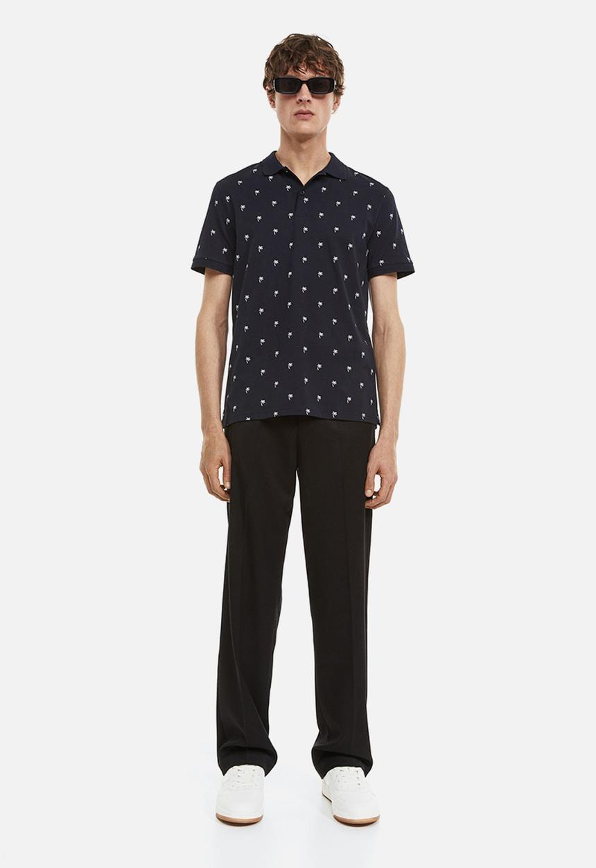 H&M - Slim fit patterned polo shirt - dark blue/palm trees
