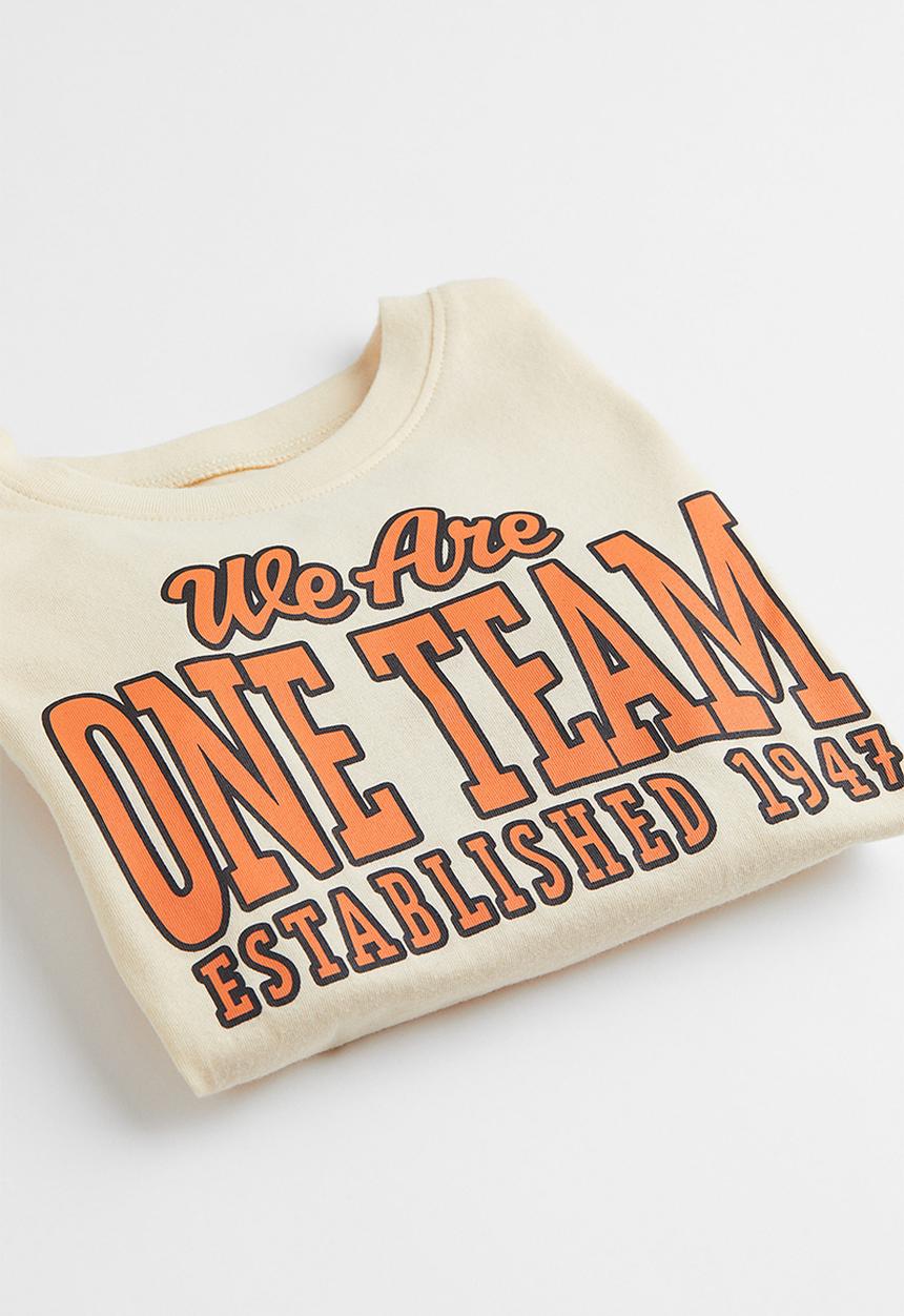 H&M - Cotton T-shirt - light yellow/we are one team