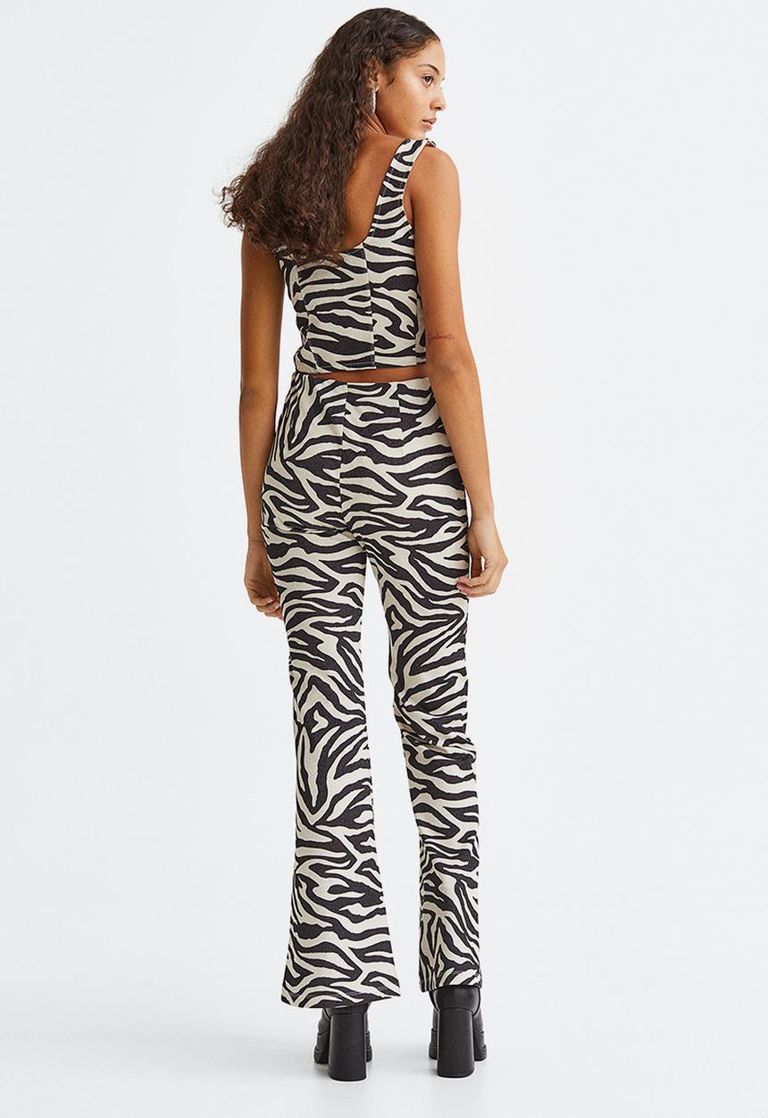 H&M - Glittery flared leggings - black/zebra print