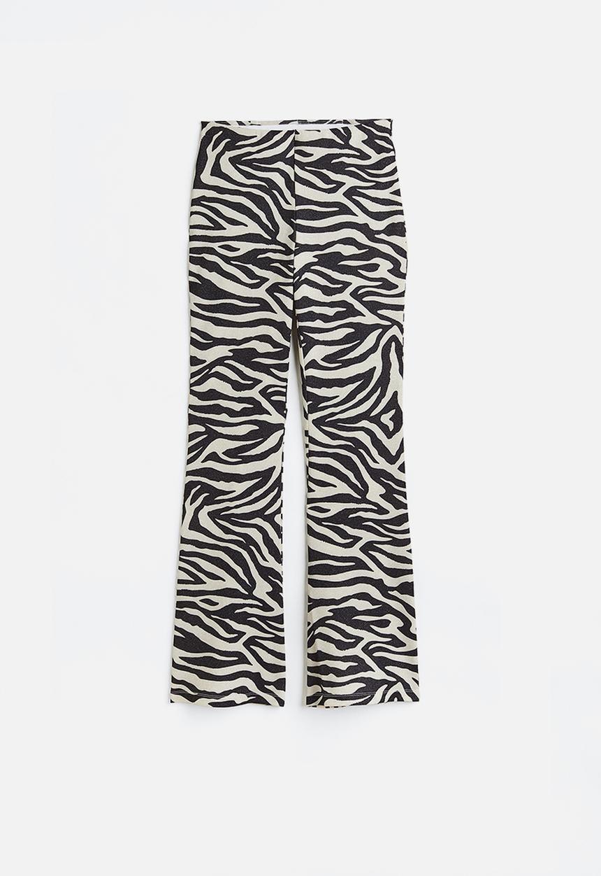 H&M - Glittery flared leggings - black/zebra print