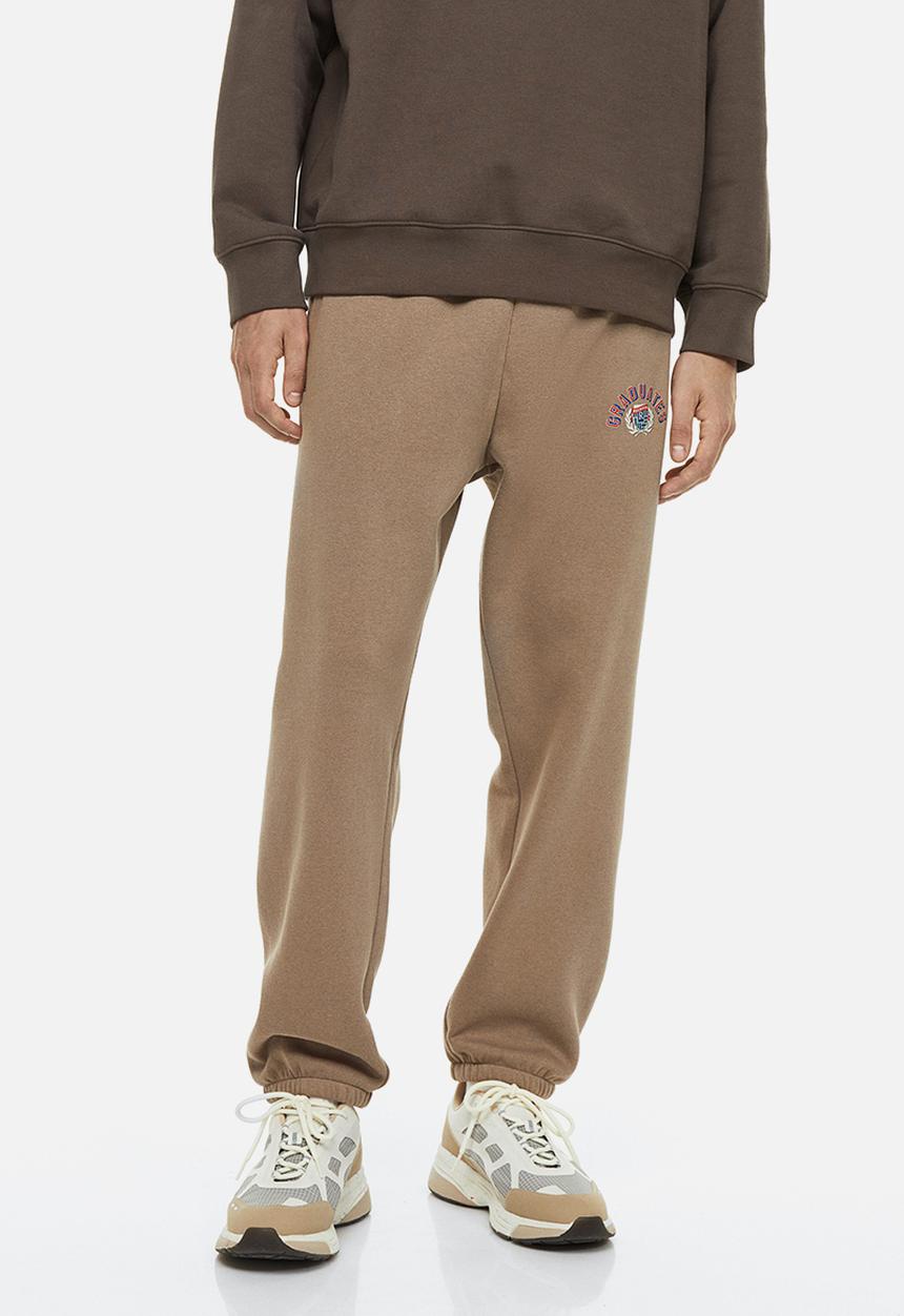 H&M - Relaxed fit printed sweatpants - beige/graduates