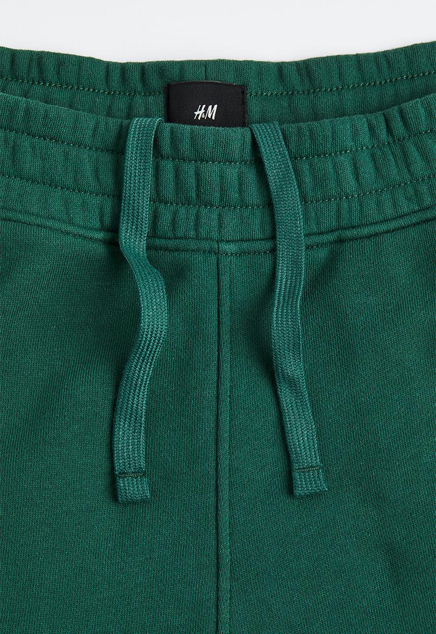 H&M - Loose fit printed sweatpants - dark green/boring pals