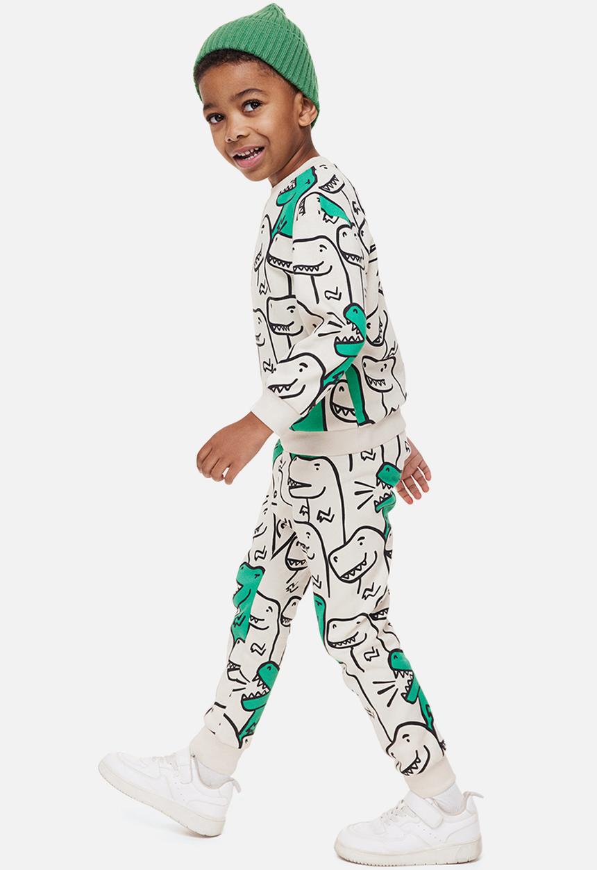 H&M - Printed joggers - light beige/dinosaurs 