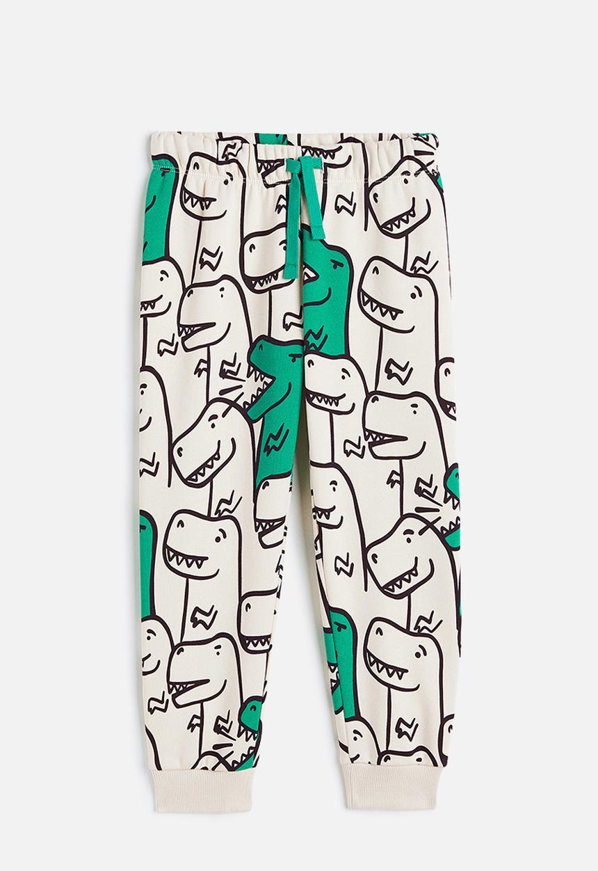 H&M - Printed joggers - light beige/dinosaurs 