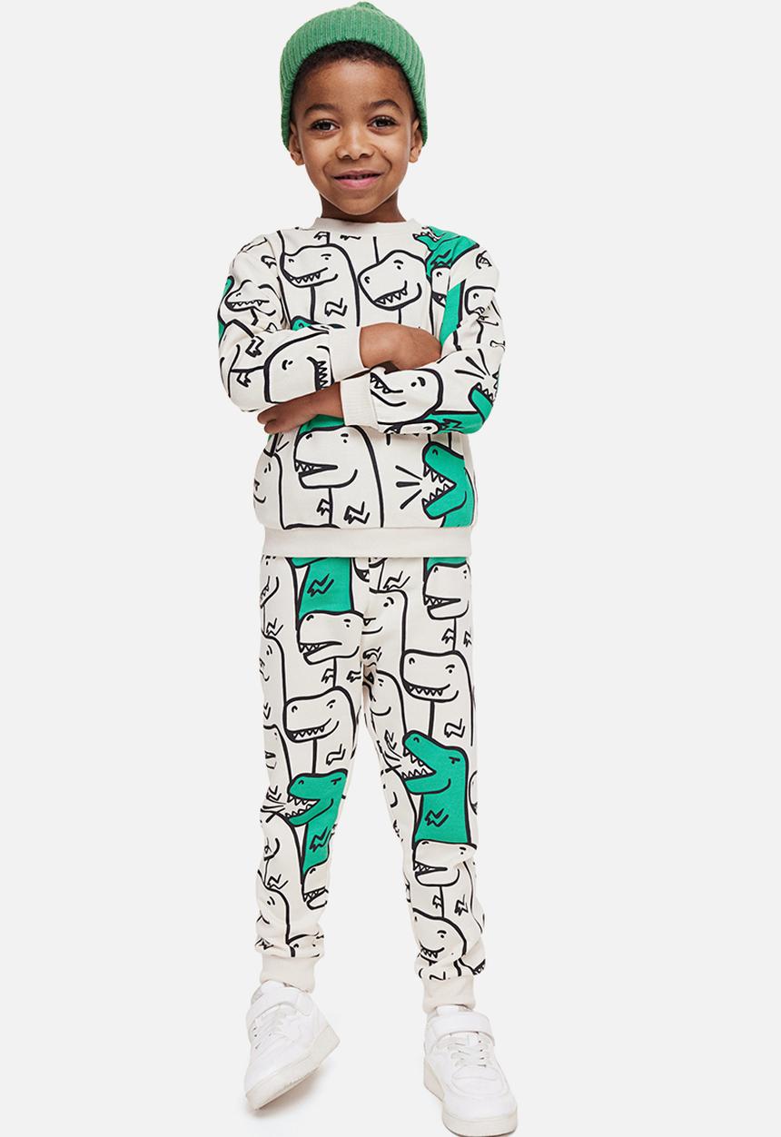 H&M - Printed joggers - light beige/dinosaurs 