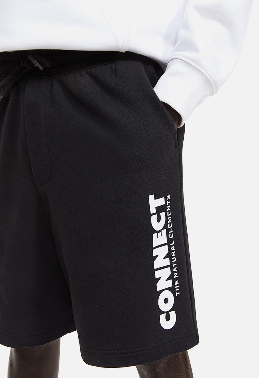 H&M - Relaxed fit printed sweatshorts - black connect 