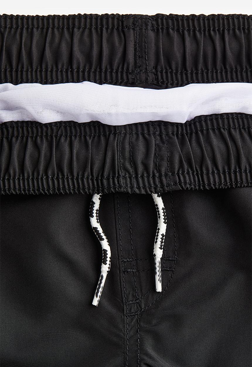 H&M - Swim shorts - black & surf vibes 