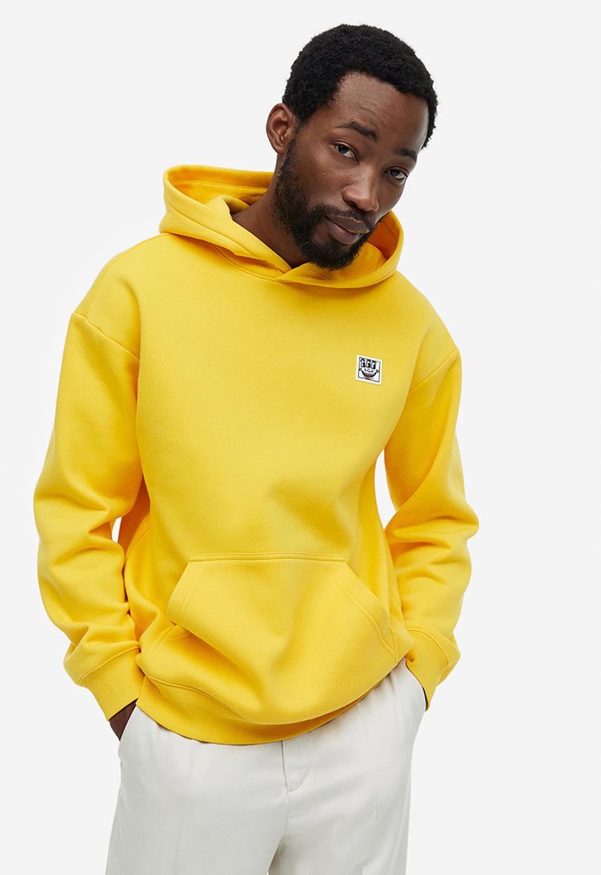 H&M - Relaxed fit hoodie - yellow keith haring