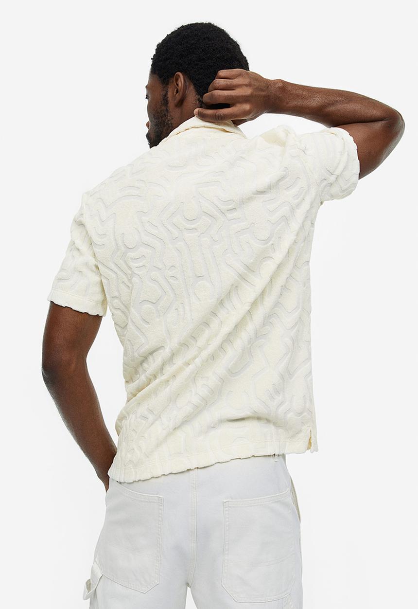 H&M - Regular fit terry polo shirt - cream keith haring