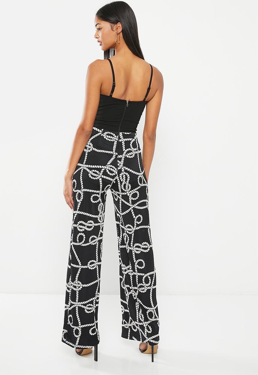 SISSY BOY - Mixed jumpsuit with leg opening - black chain print