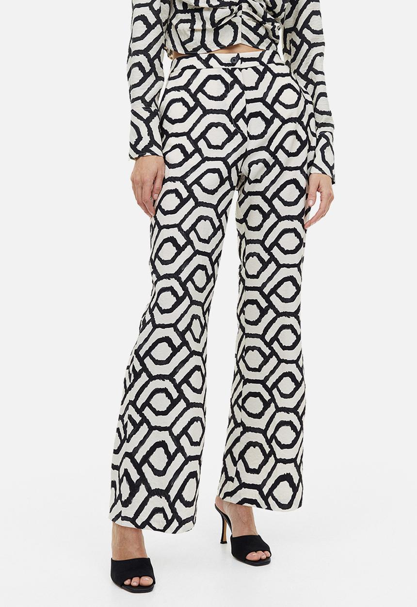 H&M - Flared trousers - cream patterned 