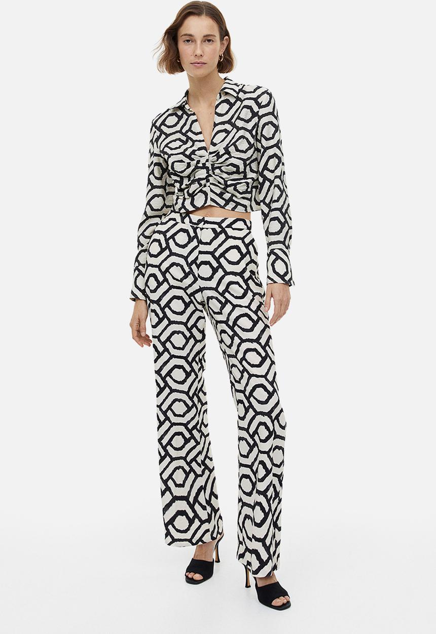 H&M - Flared trousers - cream patterned 