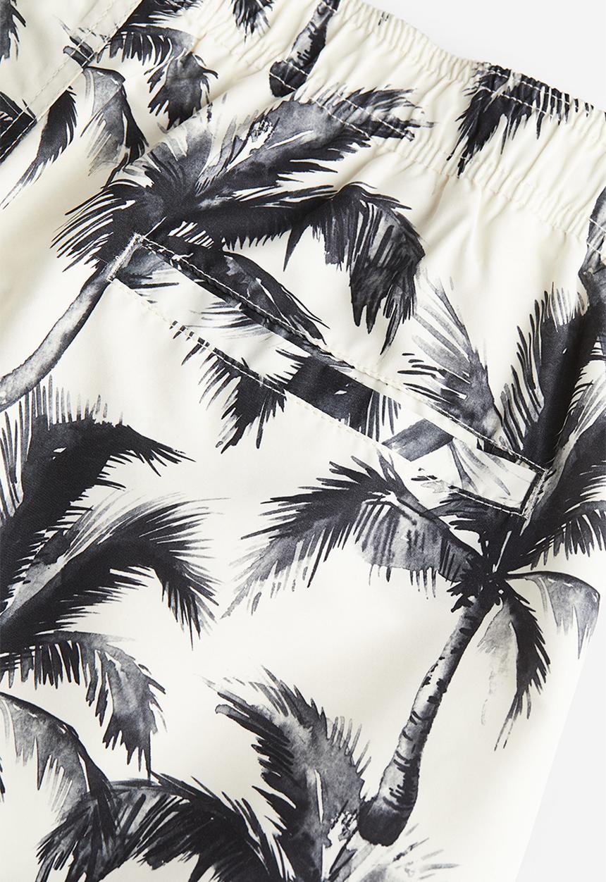 H&M - Patterned swim shorts - white palm trees