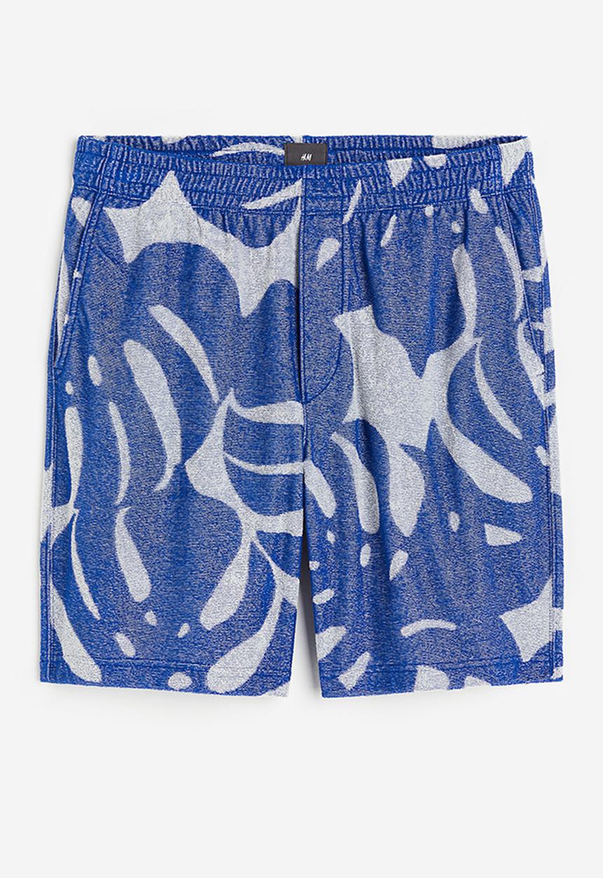 H&M - Regular fit terry shorts - blue leaf-patterned 