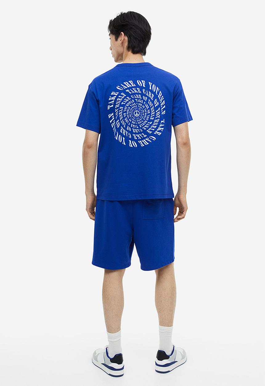 H&M - Coolmax® loose fit sweatshorts - Bright blue Peace symbol