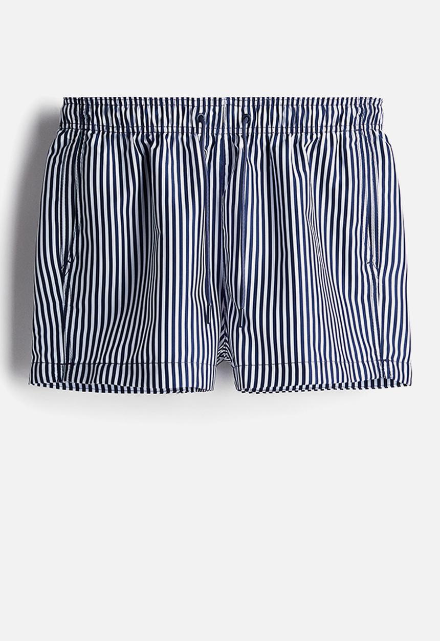H&M - Patterned swim shorts - dark blue/striped