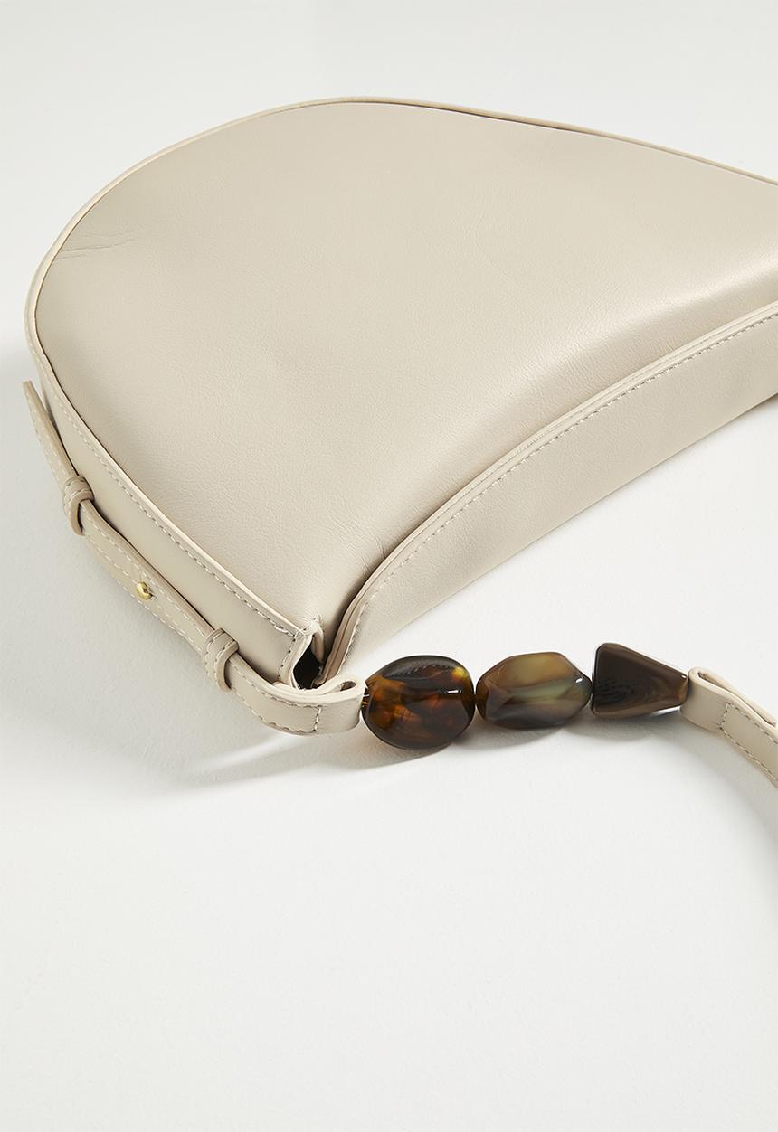 Tessa Design - Crescent shaped shoulder bag with beaded strap detail - cream