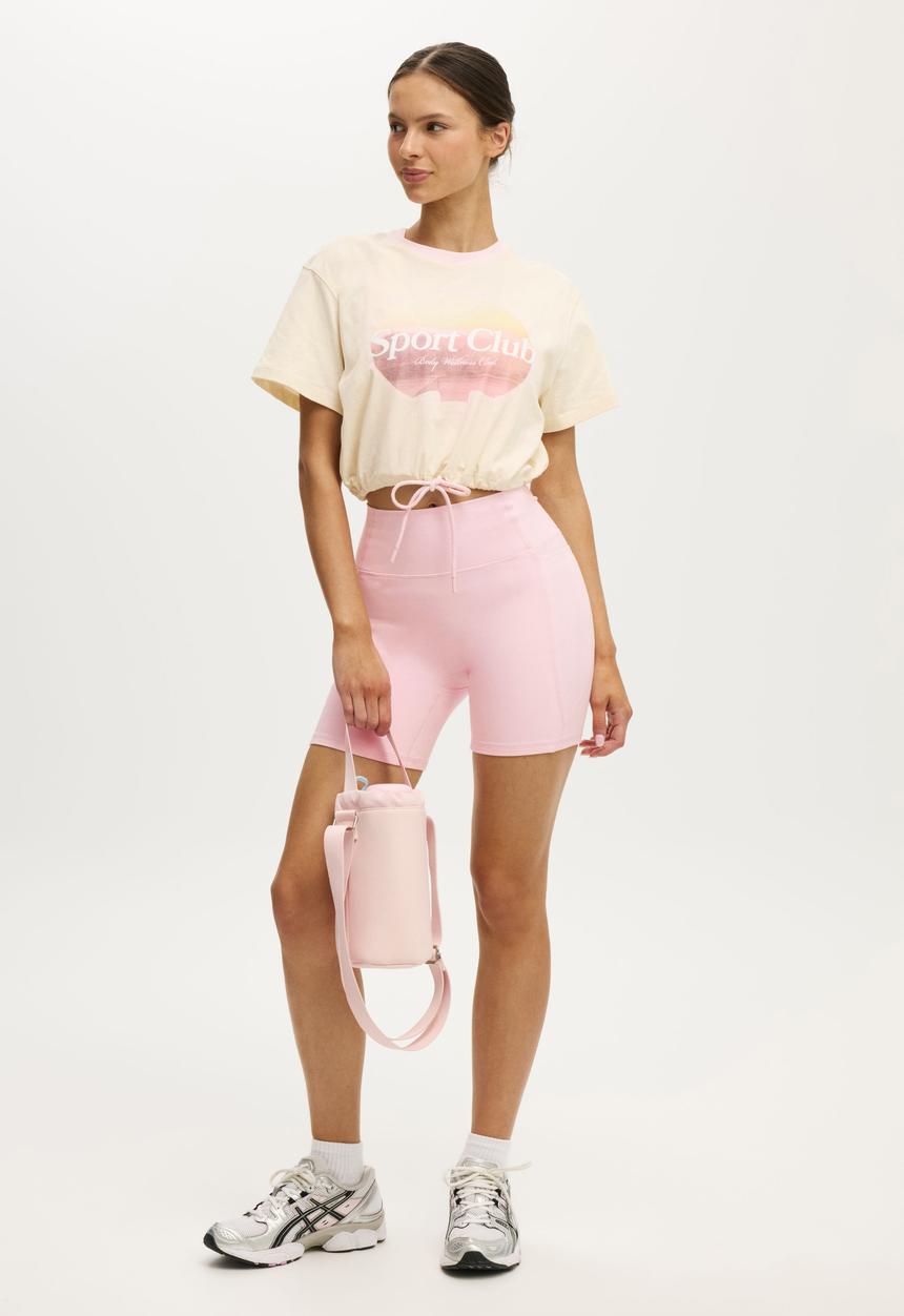 Cotton On - Active Graphic Tie Up Tee - Coconut Milk/Sport Club