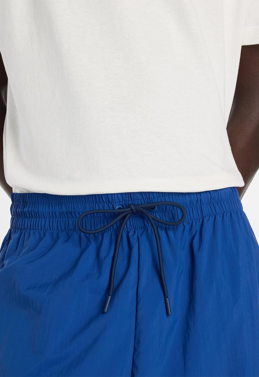 New Balance  - NB Athletics Sport Legacy Pant - Blue
