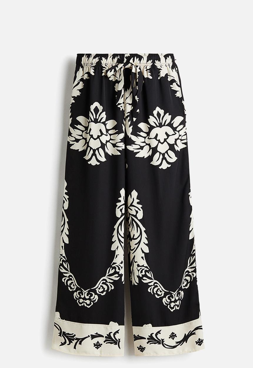 H&M - Wide trousers - black/patterned