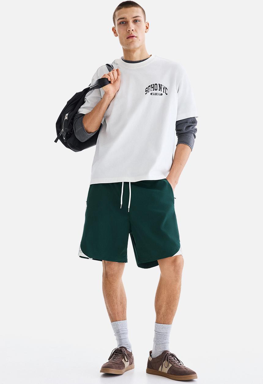 H&M - Regular fit track shorts - dark green/colour block