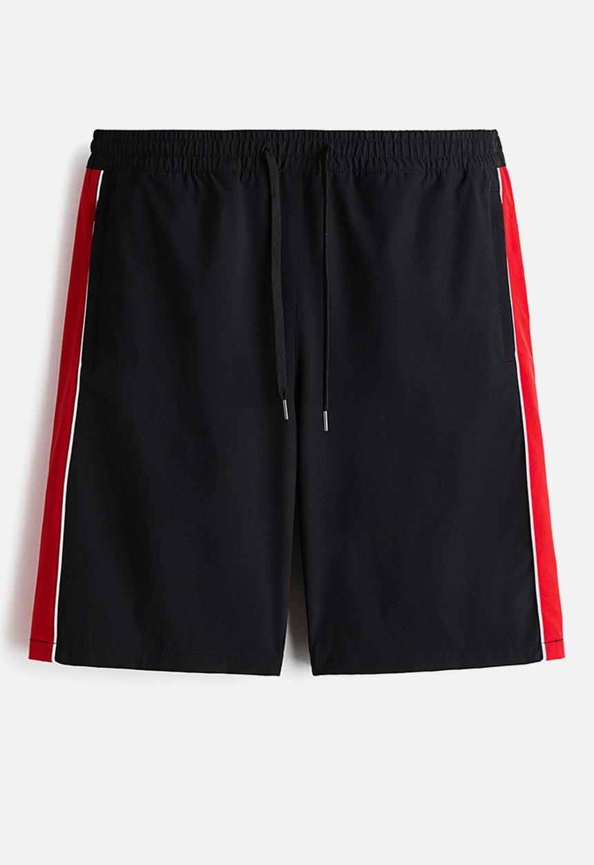 H&M - Loose fit printed shorts - black/honda