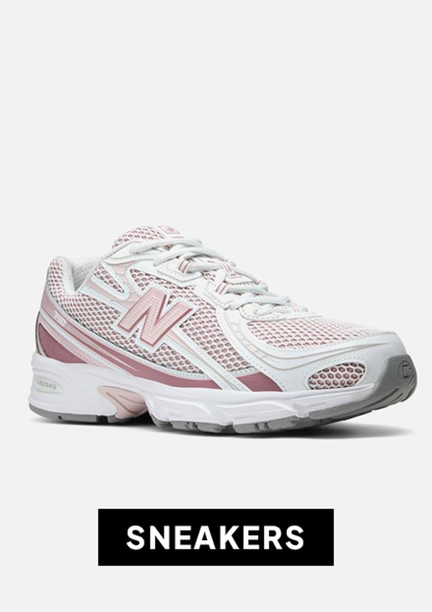 A white and pink New Balance sneaker on a plain light background with a black friday “SNEAKERS” label below.