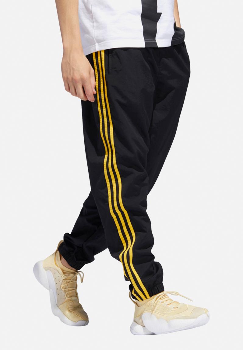 adidas Woven block pants - black/bold gold adidas Originals Sweatpants ...