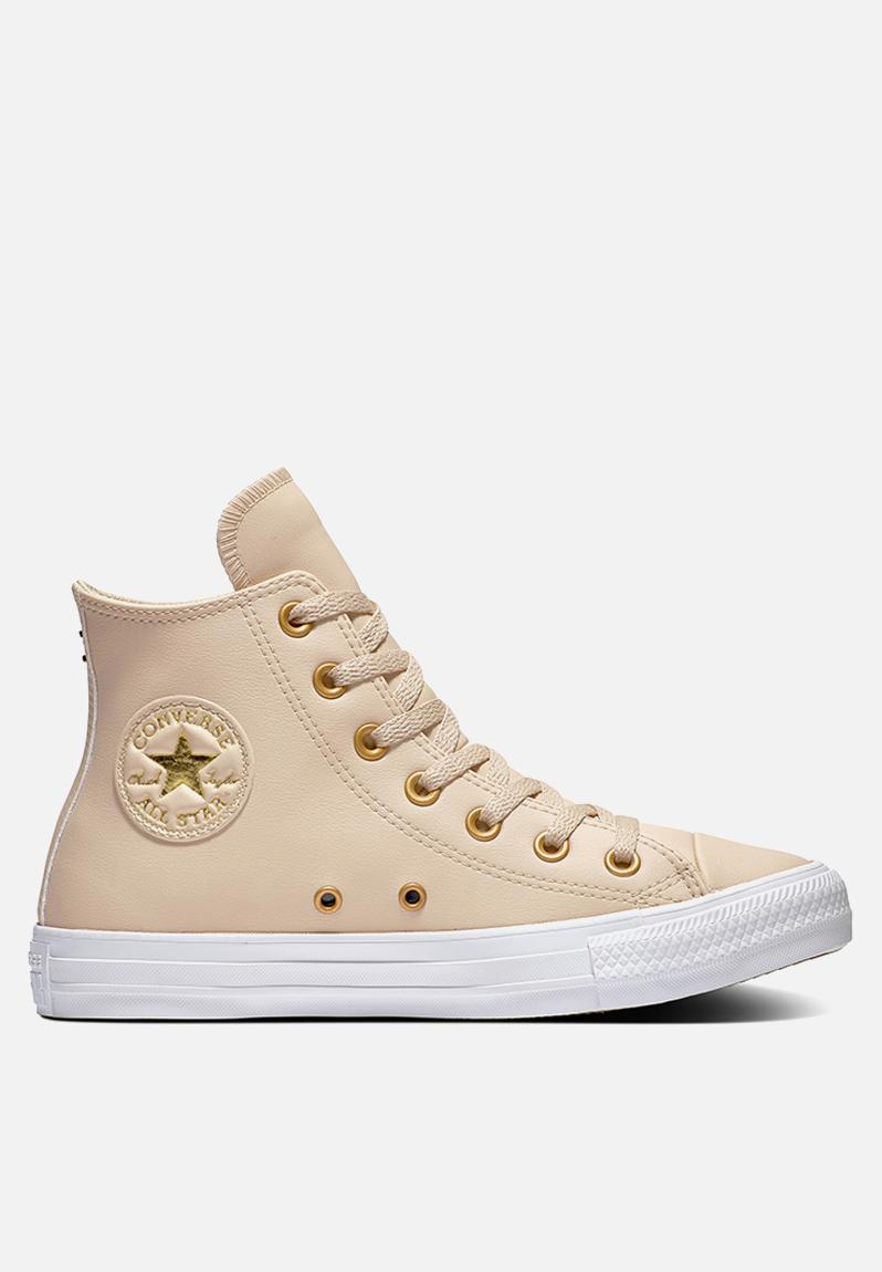 white converse with gold eyelets